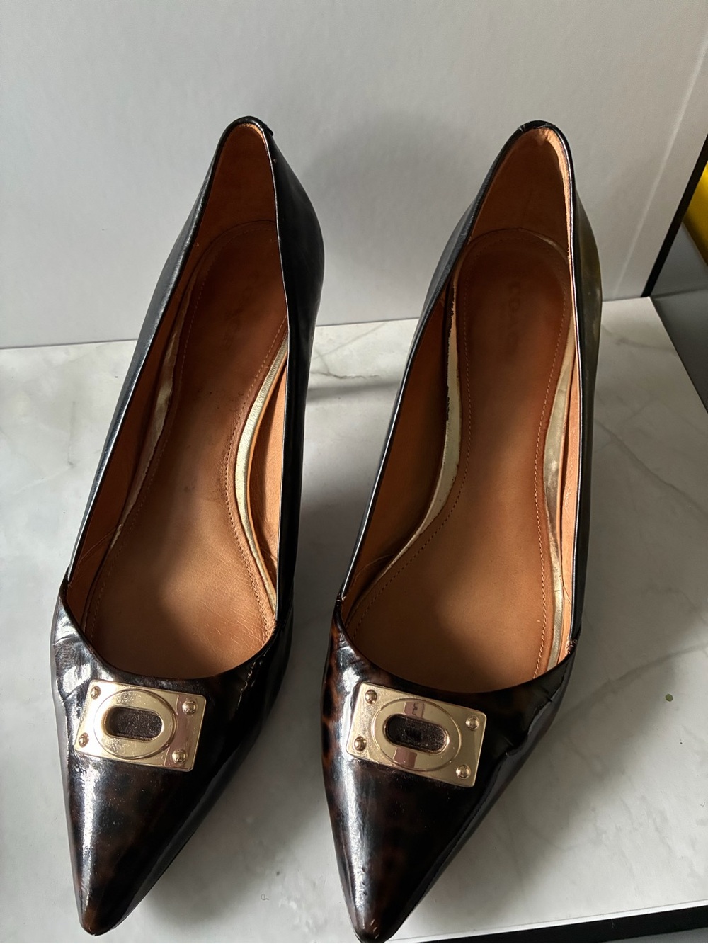 Coach Black Patent Pointed-Toe Pumps with Gold Plaque